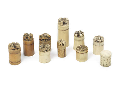 A group of ten cylindrical ivory boxes and covers