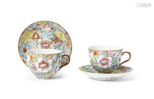 A pair of famille rose 'millefleur' coffee cups and saucers