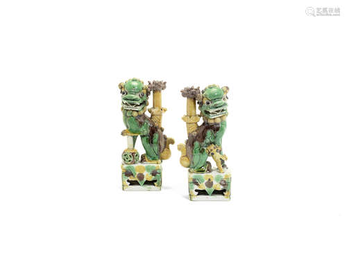 A pair of famille verte biscuit 'Buddhist lion' joss stick holders