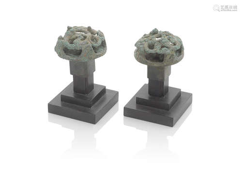 A pair of circular bronze fittings