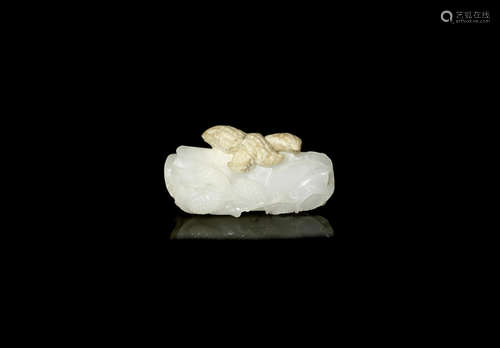 A rare and unusual white and calcified jade 'lotus, lychee and peanut' pendant