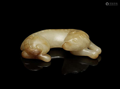 A yellow and russet jade figure of a recumbent hound