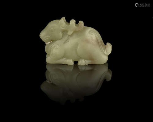 A yellow jade carving of a recumbent deer