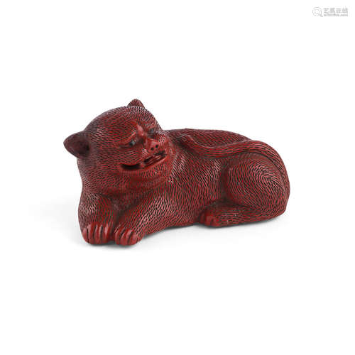 CINNABAR LACQUER FIGURE OF A RECUMBENT LION QING DYNASTY, 19TH CENTURY