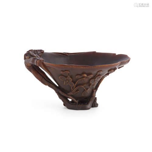 Y CARVED RHINOCEROS HORN 'PRUNUS' LIBATION CUP QING DYNASTY, 18TH/19TH CENTURY