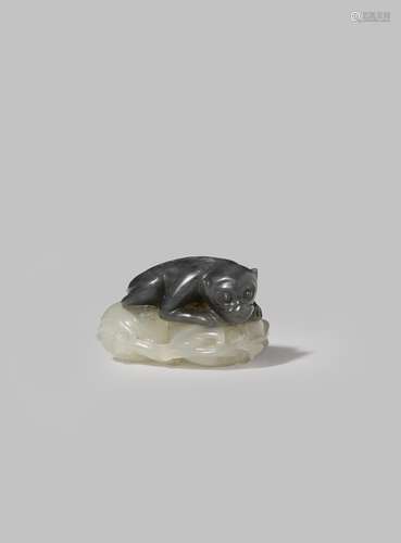 A SMALL CHINESE PALE CELADON AND GREY JADE CARVING OF A MONKEY