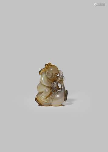 A SMALL CHINESE AGATE CARVING OF A BOY