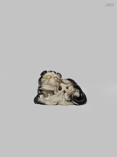 A CHINESE BLACK AND GREY JADE MODEL OF A BUDDHIST LION DOG