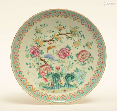 An Oriental famille rose plate with floral decoration, 19thC, Diameter 40 cm (chip on the rim)