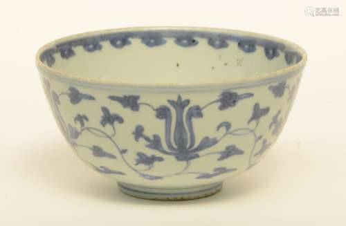 A Chinese blue and white bowl, overall decorated with lotus vines, Ming, H 9 - Diameter 17,5 cm (chips on the rim)