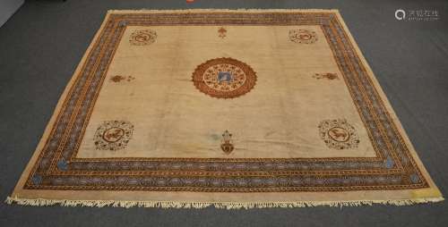 A Tibetan rug, floral decorated, the roundels with mythical animals, 427 x 446,5 cm (restoration, stains)