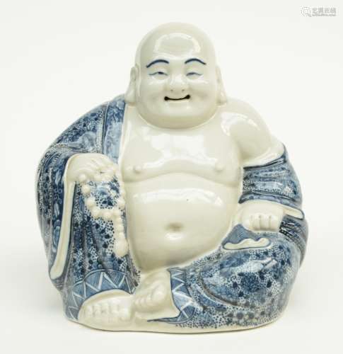 A Chinese blue and white decorated laughing Buddha, marked, H 17 cm