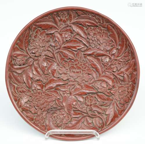 A red Peking lacquered plate with relief decorations, marked, Diameter 35 cm