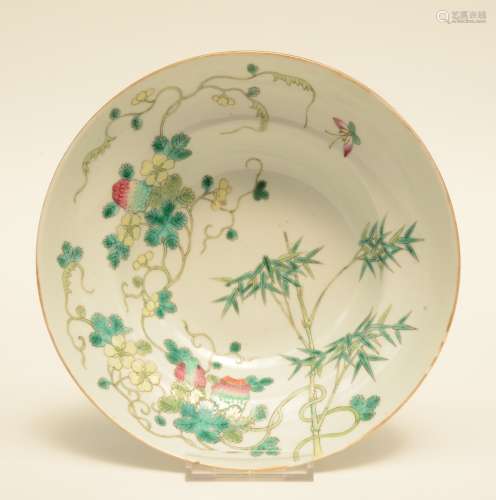 A Chinese polychrome decorated bowl painted on both inner side and outer side with a bamboo branch and fruits, ca. 1900, H 7,5 cm - Diameter 20 cm (chips on the rim and hairline)