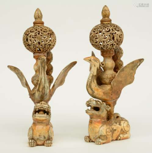 A pair of late 19thC - early 20thC ivory sculptures (out of various parts) depicting cranes travelling on the back of a kilin, both sculptures mounted with openwork decoration, tinted and gilt, H 30 cm, Total weight: 1,98 kg (flaking polychromy, junctures of the seperate parts visible)