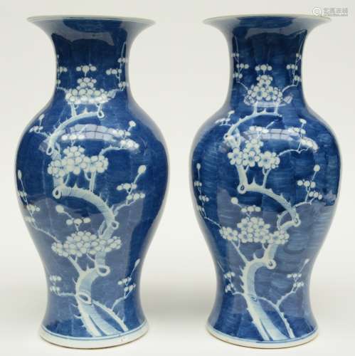 A pair of Chinese blue and white decorated vases painted with prunus blossoms, H 42,5 cm