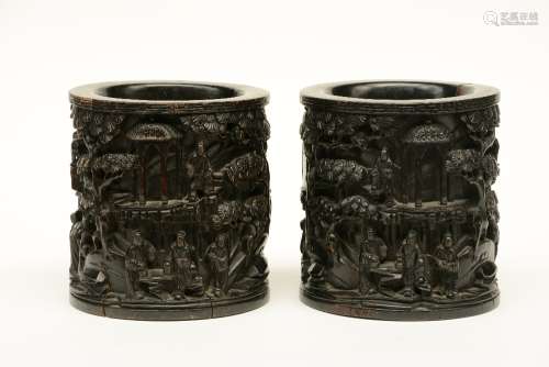 A pair of Chinese wooden pots, overall alto relievo decorated with an animated scene, ca. 1900, H 21,5 cm (cracks and minor damage)