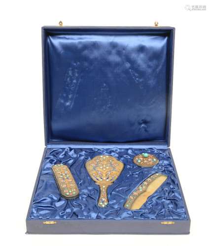 An Oriental four-piece gilt filigree silver toilet set, enamel decorated, with semi-precious stones, in its original box, H 9 - W 39,5 - D 37 cm - Weight: ca. 692 g