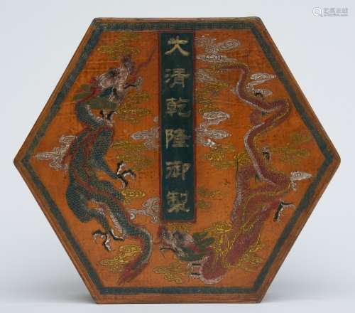 A Chinese octagonal wooden box and cover, painted with dragons and other symbols, marked Qianlong, H 8 cm - Diameter 20 cm