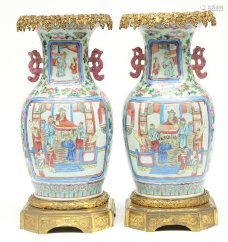A pair of Chinese famille rose vases, decorated with animated scenes and gilt bronze mounts, 19thC, H 49,5 cm (one vase with restoration)