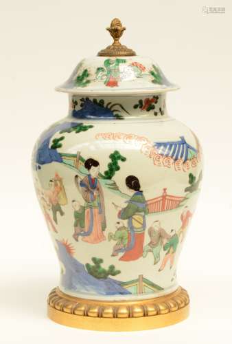 A Chinese wucai vase with cover, decorated with children playing in a garden, gilt brass mounts, 19thC, H 46,5 cm (bottom and cover perforated)