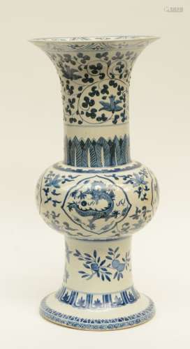 A Chinese Gu vase, blue and white decorated with dragons, floral motifs and birds, marked, H 56,5 cm (glaze defects)