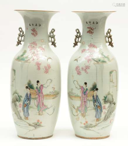 A pair of Chinese polychrome vases, decorated with two court ladies in a garden, H 58,5 cm (one with chip to the rim)