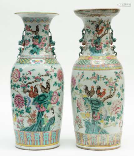 Two Chinese famille rose vases, overall decorated with cockerels on a rock and flower branches, 19thC, H 59,5 - 61 cm (one with crack on the bottom, one with crack near to the bottom)