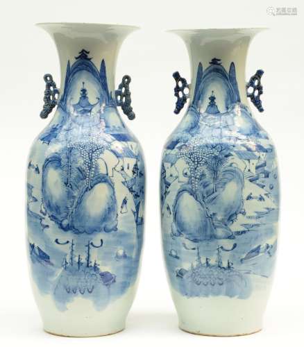 A pair of Chinese blue and white vases, decorated with figures in a mountanious landscape, H 58,5 - 59 cm (one vase with a hairline and firing fault on the top rim)