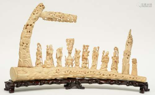 An impressive Chinese ivory sculpture, depicting the Eight Immortals, marked, on a matching wooden base, first half 20thC, H 44,5 (without base) - 50,5 (with base) - W 83,5 cm