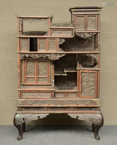 A Japanese wooden display cabinet, carved with birds, flowerbranches and a landscape, ca. 1900, H 176,5 - W 119 - D 47 cm (minor damage)