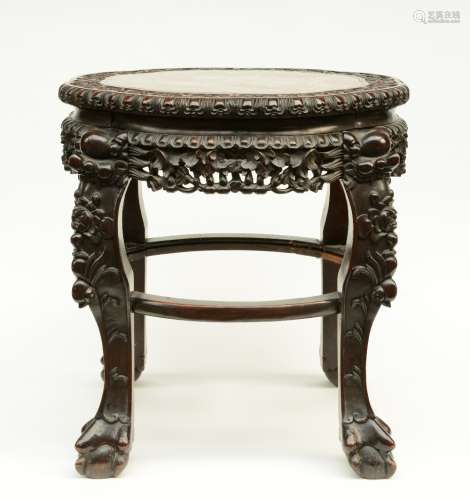 A Chinese carved wooden stool with a marble top, ca. 1900, H 58 - Diameter 65,5 cm (minor damage and restoration)