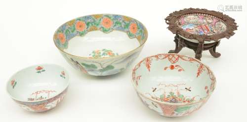 Three Chinese bowls, two Amsterdam Bont and one polychrome decorated with an animated scene, 18thC and 19thC; added a 18thC Chinese rose-mandarin saucer, with a 19thC wooden mount, H 5,5 - 8,5 - 11 - Diameter 11,5 - 15,5 - 20,5 cm (chips on the rim, hairlines, restoration)