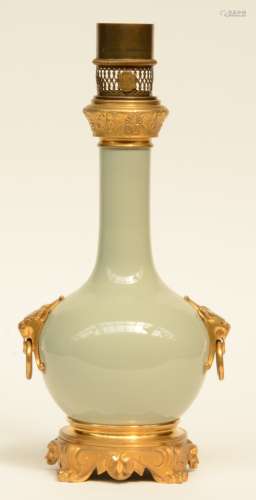 A Chinese celadon bottle vase, with gilt bronze and brass mounts, mounted into a lamp, H 45 cm