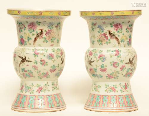 A pair of Chinese famille rose Gu vases, decorated with birds and flower branches, 19thC, H 40,5 - Diameter 26 cm (one vase with restoration on the body and one vase with restoration near to the rim)