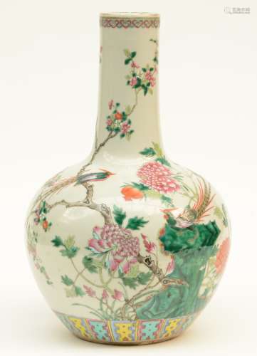 A Chinese famille rose bottle vase, decorated with flowers, a rock, butterflies and fruit, marked, 19thC, H 41,5 cm (chips on the rim - firing faults)