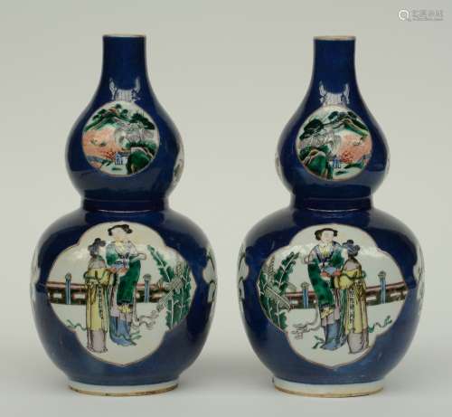 A pair of Chinese blue poudré double-gourd vases, the roundels famille verte decorated with river landscapes, animated scenes and flower branches, marked Qianlong, H 32,5 cm (chip and firing fault)