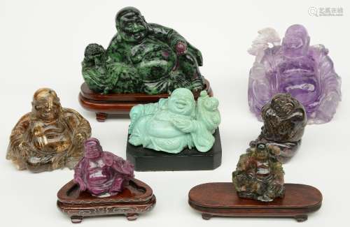 Seven Chinese laughing Buddai, in various semi-precious stones, some on a wooden base, H 5 - 10 cm