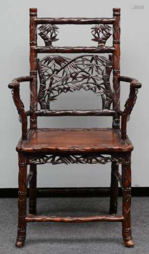 A Chinese hardwood armchair, carved bamboo imitation, H 104 - W 59,5 cm (minor damage)