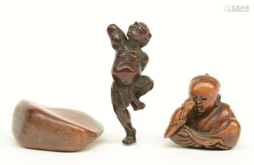 Three Japanese wooden katabori netsuke, one depicting a dancer; one a crying kabuki actor (signed), and one a nut, late Edo-period, the dancer H 5 - the actor W 3,1 - the nut W 4,2cm.