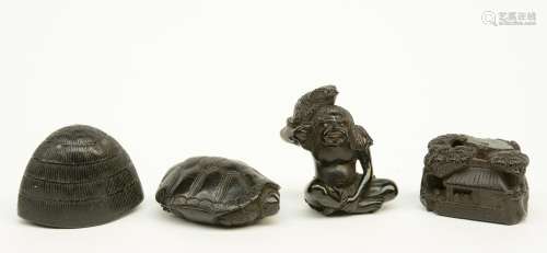 Four Japanese ebony netsuke depicting: one a man with a toad, signed; one a cottage in a landscape; one a turtle and one an inverted cage, late Edo - / early Meiji-period, the man with the toad H 4,3; the others W 4,5 - 4,1 - 3,5 cm