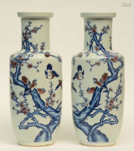 A pair of Chinese blue and white and cupper red glazed rouleau shaped vases, decorated with birds on a flower branch, H 61,5 cm