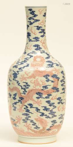 A Chinese blue and white and cupper red glazed bottle vase, decorated with dragons amid clouds, H 58,5 cm