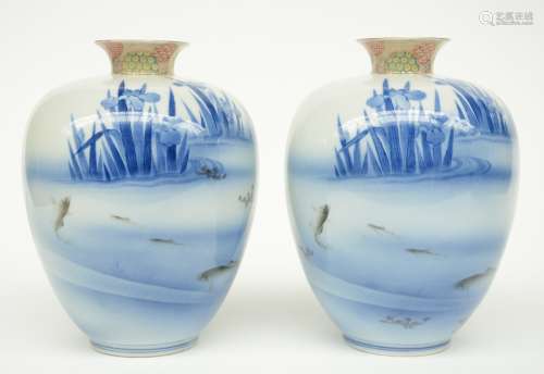 A pair of Japanese polychrome vases, decorated with fish in a river, marked, early 20thC, H 22 cm
