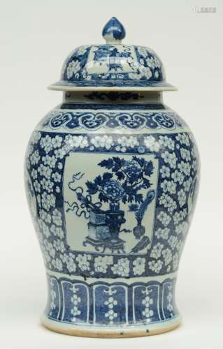 An impressive Chinese blue and white decorated vase and cover, painted with vases of flowers, antiquities and floral motifs, 19thC, H 63 cm (cover with chip and flaking of the glaze)