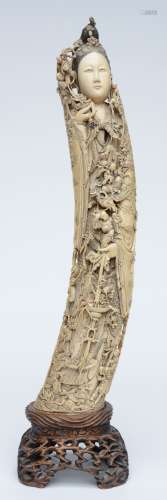 An exceptional and richly carved ivory Guanyin, accompanied by the Eight Immortals, decorated with Imperial and Buddhist symbols, Qing period, first half 19thC, scrimshaw decorated, on a matching wooden base, H 67 (with base) - 58 (without base) cm (negligible damage) (collector's item)