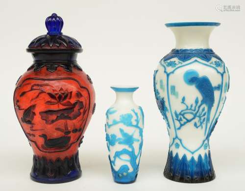 Two Chinese vases and a vase and cover, in colored and laminated glass, decorated with birds and flower branches, marked, H 15 - 27,5 cm (one vase with hairline on the body)