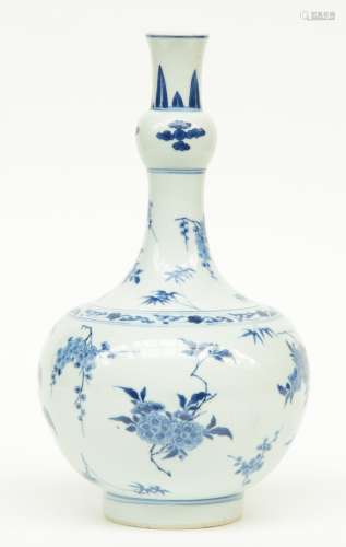 A 17thC Chinese blue and white nodule vase, decorated with flower branches, H 34,5 cm (chip on the rim)