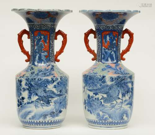 A pair of late 19thC Japanese blue and white and polychrome vases, decorated with peacocks, the panels with mountanious landscapes, marked with six characters, H 59,5 cm (one handle restored)