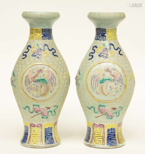 A pair of Chinese celadon ground baluster shaped vases polychrome and relief moulded with dragons, antiquities and symbols, marked, 19thC, H 43,5 cm